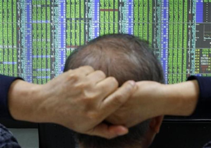 A man monitors stock market prices inside a brokerage in Taipei