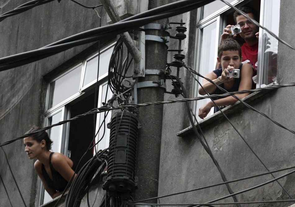 Residents take picture during the quotShock of Peacequot operation to install Peacekeeping Unit UPP at Rocinha slum in Rio de Janeiro November 13, 2011.