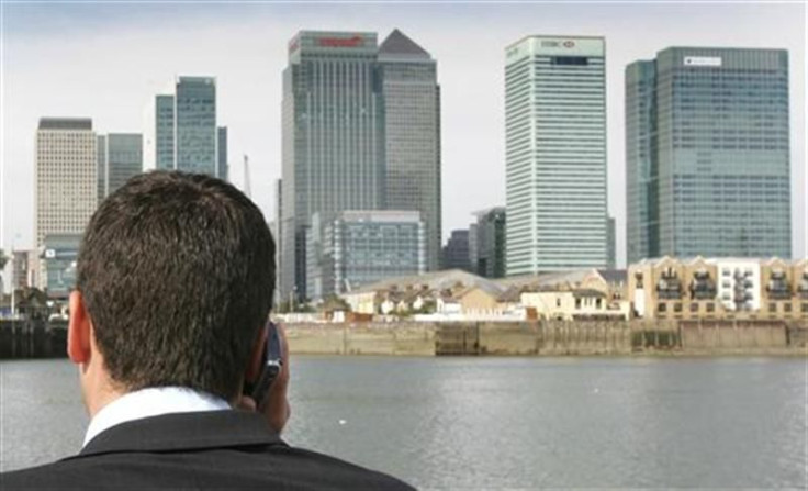 Man speaks on his mobile phone on a boat on the River Thames.