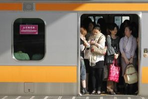 Women board a &quot;women only&quot; passenger train during morning rush hours in Tokyo