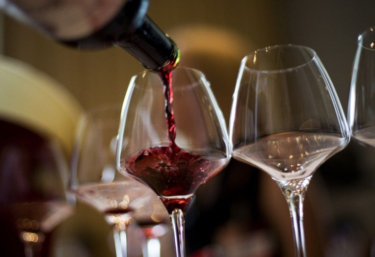 A waiter serves a glass of red wine at a tasting in Hong Kong in May 2008.