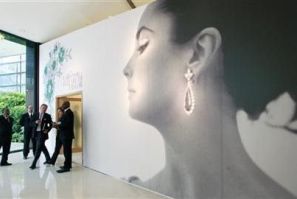 Visitors walk past the entrance of Christie&#039;s auction of The Collection of Elizabeth Taylor featuring her jewellery, haute couture, fashion, and fine arts during a press preview at Emirates Towers in Dubai October 23, 2011.