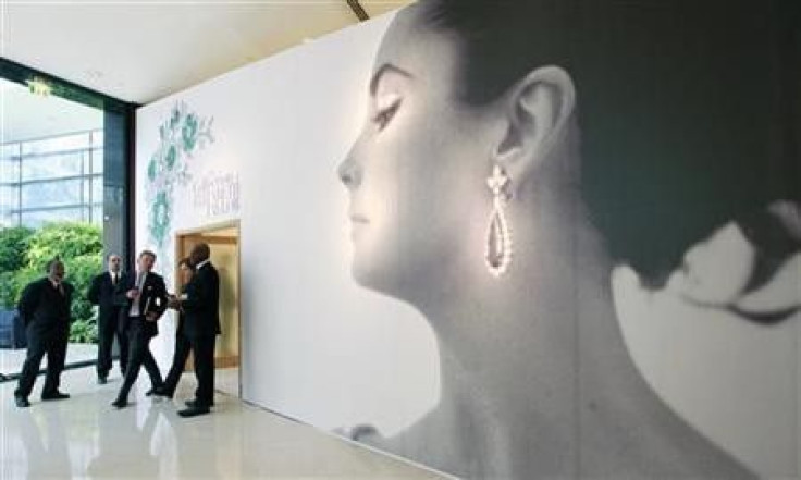 Visitors walk past the entrance of Christie&#039;s auction of The Collection of Elizabeth Taylor featuring her jewellery, haute couture, fashion, and fine arts during a press preview at Emirates Towers in Dubai October 23, 2011.