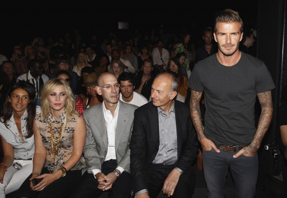 Soccer star David Beckham R stands in front of singer Natasha Bedingfield 2nd L and Adidas executive Erich Stamminger 2nd R before a presentation of the Y-3 SpringSummer 2013 collection during a walk through at New York Fashion Week September 9, 20