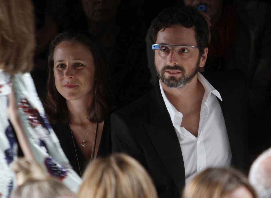 Google founder Sergey Brin R and a guest watch the the Diane von Furstenberg SpringSummer 2013 collection show during New York Fashion Week September 9, 2012. The show was used as a launching event for Googles new product quotGlass by Googlequot. 