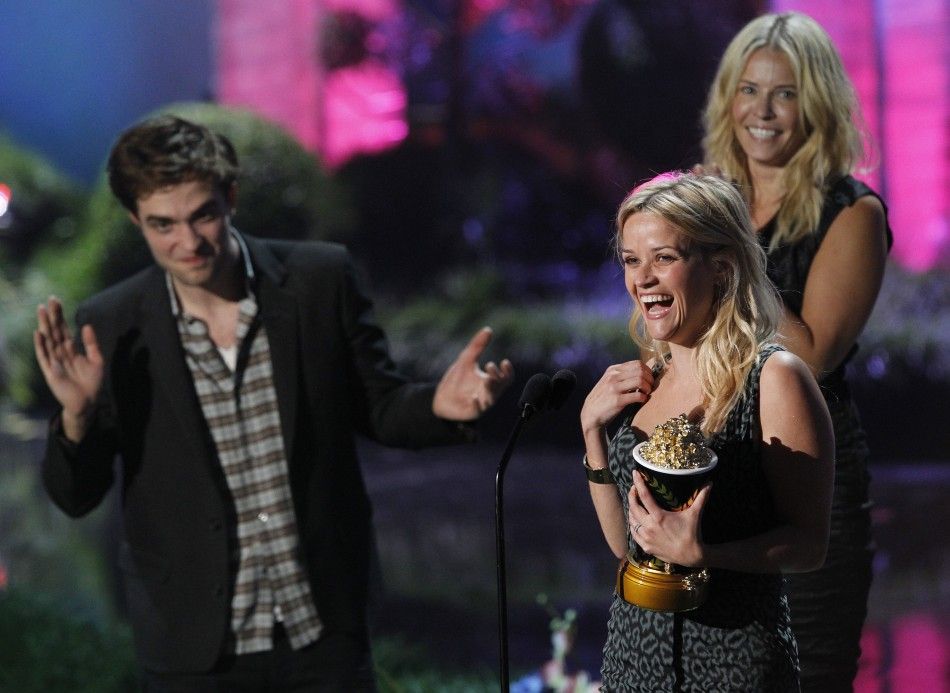Presenters Robert Pattinson and Chelsea Handler watch Reese Witherspoon as she accepts the MTV Generation Award in Los Angeles