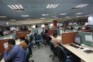 Employees work on the floor of the outsourcing company WNS in Mumbai March 19, 2012.