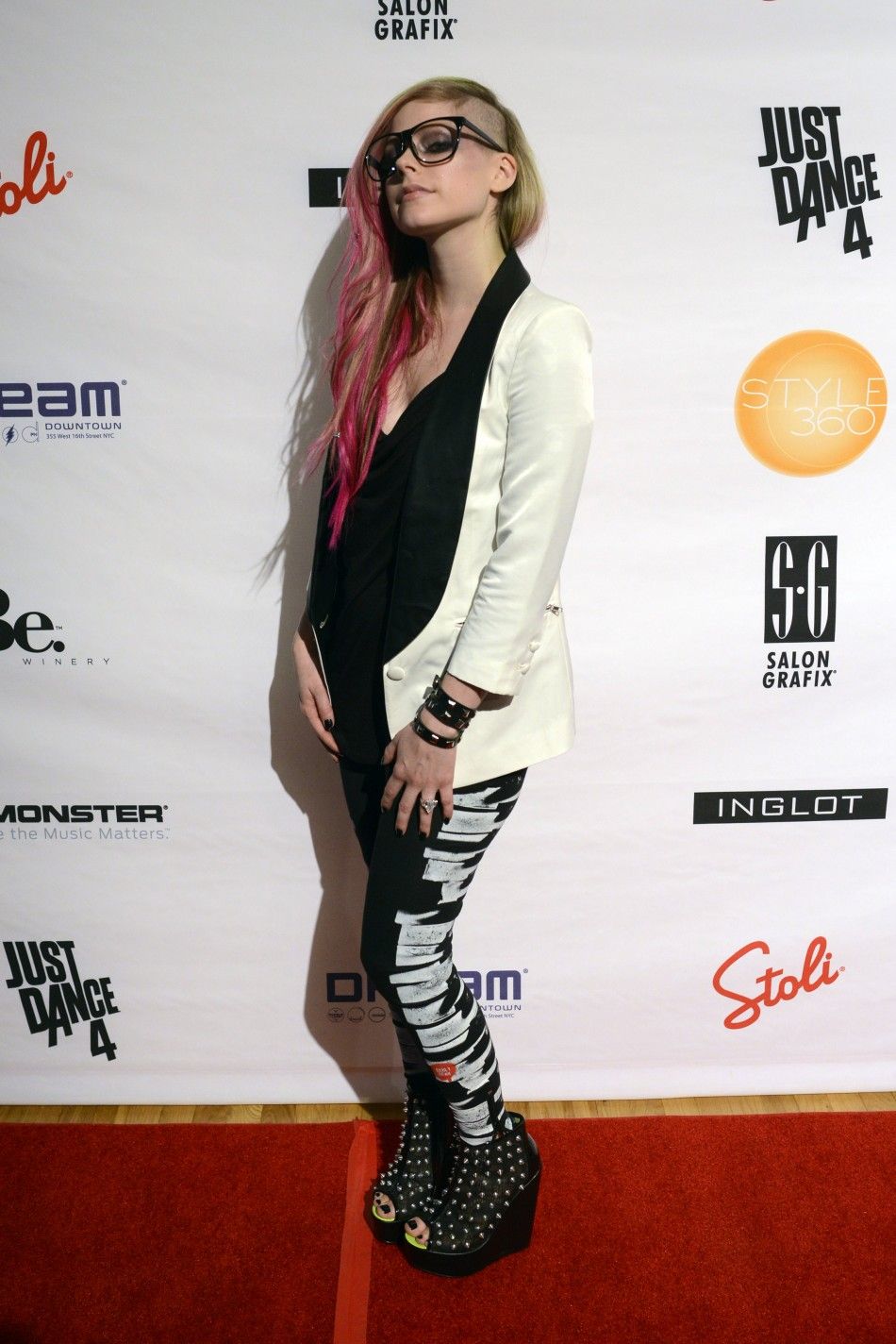 Pop singer and designer Avril Lavigne poses for photographers after the presentation of her Abbey Dawn SpringSummer 2013 collection during New York Fashion Week September 10, 2012. 