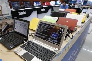 A shop attendant sits behind laptops at a computer mall in Taipei