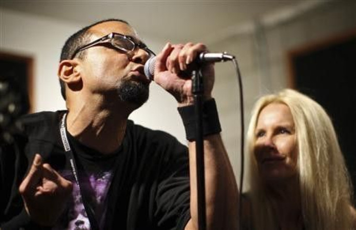 Guitarist and vocalist Lita Ford (R), a founding member of the 1970s female rock group The Runaways, coaches a participant and singer Ujesh Desai during a rehearsal at the Rock ‘n’ Roll Fantasy Camp in Los Angeles, California, November 11, 2011.