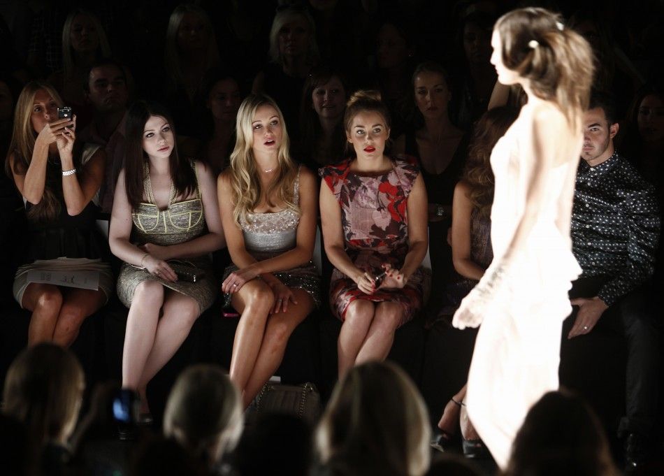 Actresses Michelle Trachtenberg 2nd L, Katrina Bowden 3rd L and television personality Lauren Conrad 4th L watch the Badgley Mischka SpringSummer 2013 collection show at New York Fashion Week September 11, 2012. 
