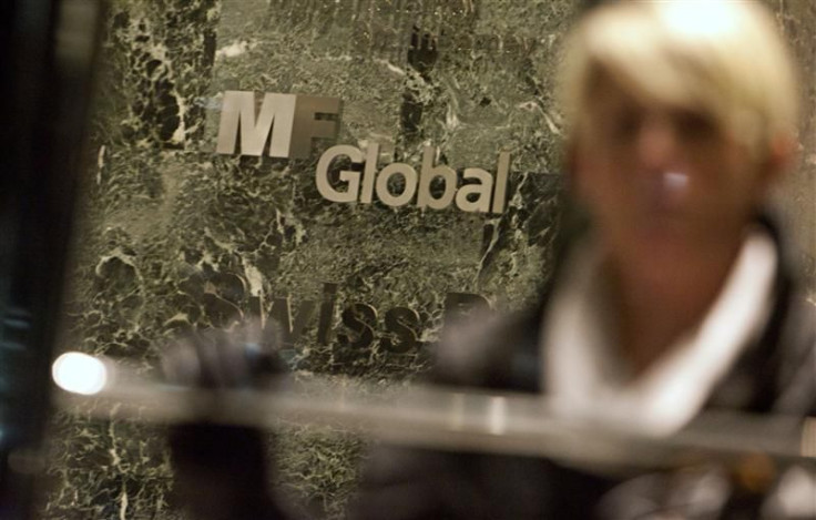 A woman leaves the office complex where MF Global Holdings Ltd have an office on 52nd Street in midtown Manhattan