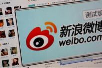 The logo of Sina Corp&#039;s Chinese microblog website &quot;Weibo&quot; is seen on a screen in this photo illustration taken in Beijing