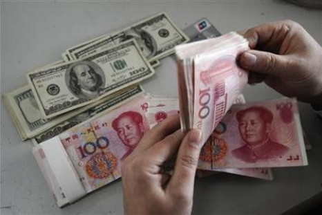 An employee counts Renminbi banknotes at a Bank of China branch in Changzhi, Shanxi province Nov. 16, 2009.