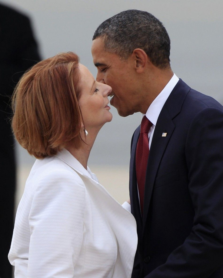 U.S. President Obama kisses Australian Prime Minister Gillard as he arrives in Canberra