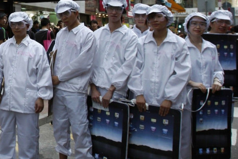 Local and mainland Chinese university students dress as Foxconn workers during a rally in Hong Kong in May, demonstrating against the &quot;dire&quot; working conditions of workers from Foxconn and Apple.