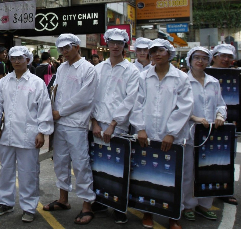 Local and mainland Chinese university students dress as Foxconn workers during a rally in Hong Kong in May, demonstrating against the &quot;dire&quot; working conditions of workers from Foxconn and Apple.