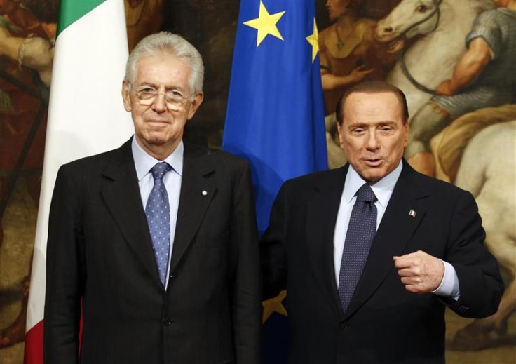 Newly appointed Prime Minister Monti poses with his predecessor Berlusconi at Chigi palace in Rome