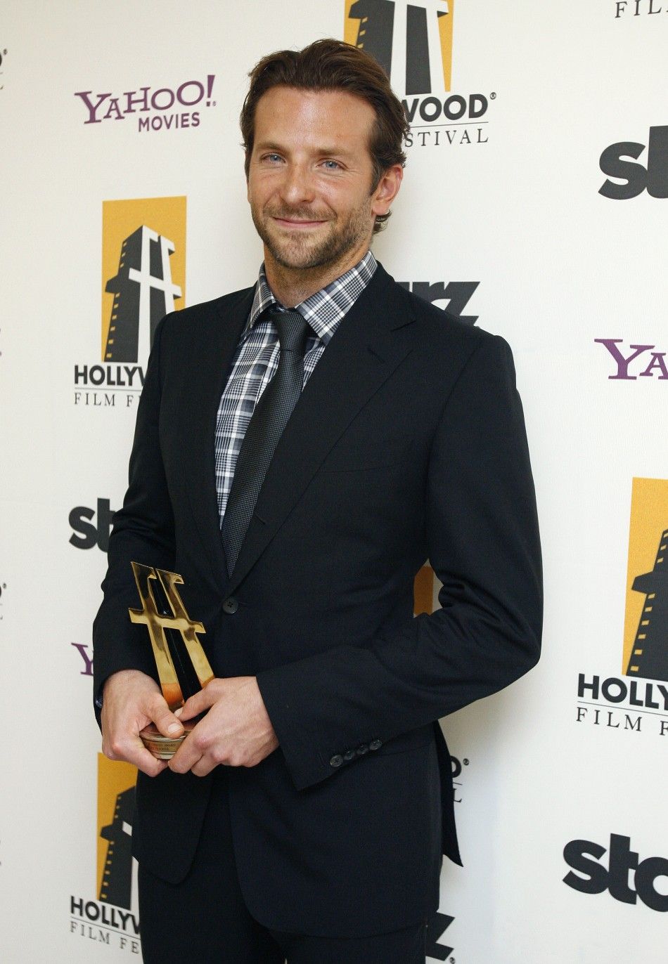 Cooper poses after accepting the Comedy Award at the 13th annual Hollywood Awards gala in Beverly Hills