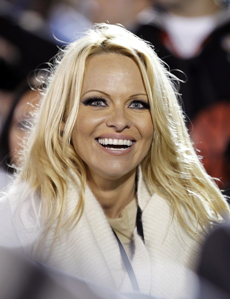Pamela Anderson watches the NCAA Carrier Classic mens college basketball game between Michigan State Spartans and the North Carolina Tar Heels in Coronado