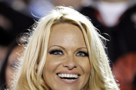 Pamela Anderson watches the NCAA Carrier Classic men's college basketball game between Michigan State Spartans and the North Carolina Tar Heels in Coronado