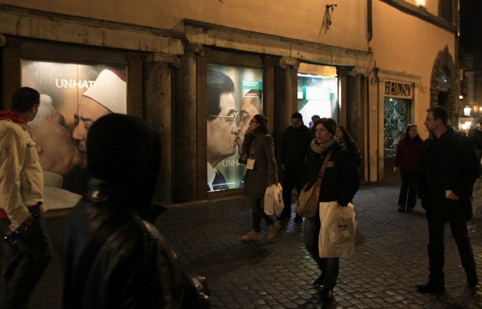 People stroll in front of the Benetton store in downtown Rome