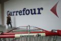 A customer walks past a Carrefour outlet in Kuala Lumpur