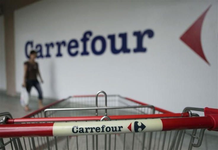 A customer walks past a Carrefour outlet in Kuala Lumpur