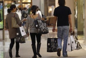 Shoppers carry their purchases during the Black Friday sales at a shopping mall in Tysons Corner