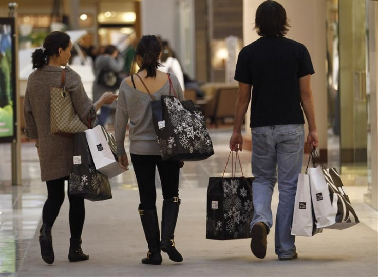 Shoppers carry their purchases during the Black Friday sales at a shopping mall in Tysons Corner