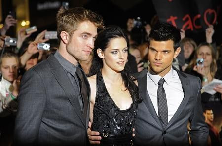 Actors Robert Pattinson (L), Kristen Stewart (C) and Taylor Lautner arrive for the British premiere of 'The Twilight Saga: Breaking Dawn' at Westfield in east London