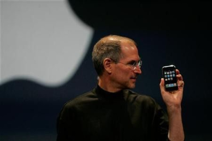 Apple Computer Inc. Chief Executive Officer Steve Jobs holds the new iPhone in San Francisco, California