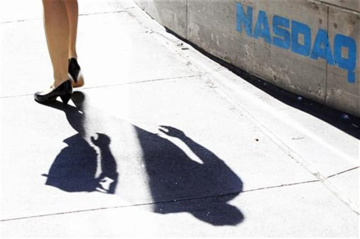 A pedestrian walks past the NASDAQ building in New York City