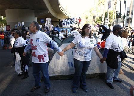 Protesters, organized by Good Jobs LA and Occupy Los Angeles, demonstrate in the downtown financial district of Los Angeles, California