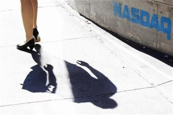 A pedestrian walks past the NASDAQ building in New York City