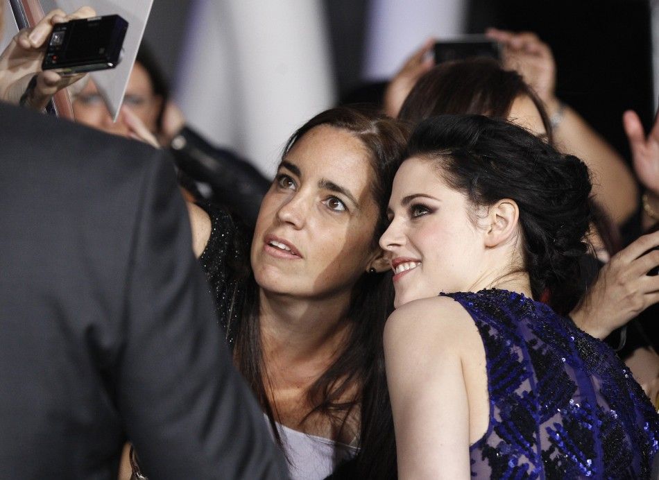 Stewart poses with a fan at the premiere of quotThe Twilight Saga Breaking Dawn - Part 1quot in Los Angeles