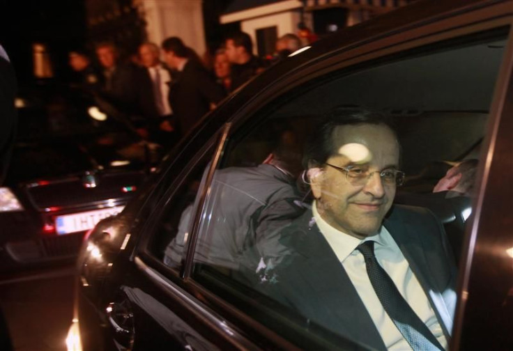 Antonis Samaras smiles as he leaves the presidential palace after a meeting with President Karolos Papoulias and Prime Minister George Papandreou in Athens