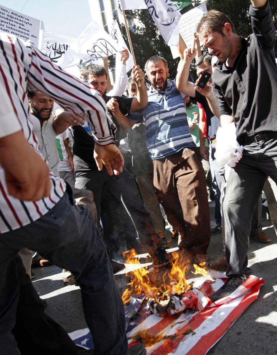 Muslim protesters, who have taken issue with the depiction afforded the Prophet Muhammad in an American film, burn the U.S. flag in Ankara, Turkey.