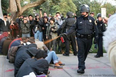 UC Davis Police Lt. John Pike dousing seated students with pepper spray