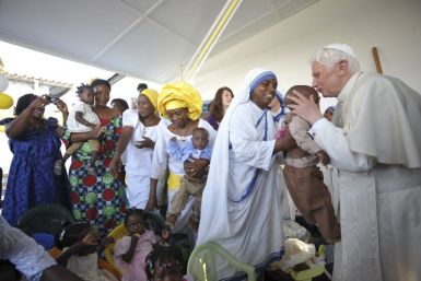 Pope Benedict XVI kisses a child during his visit to foyer &quot;Paix et Joie&quot; at the St. Rita church in Cotonou, during his pastoral visit in Benin