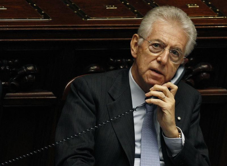 Italy's Prime Minister Mario Monti talks on the phone during a vote of confidence at the Lower House of Parliament in Rome