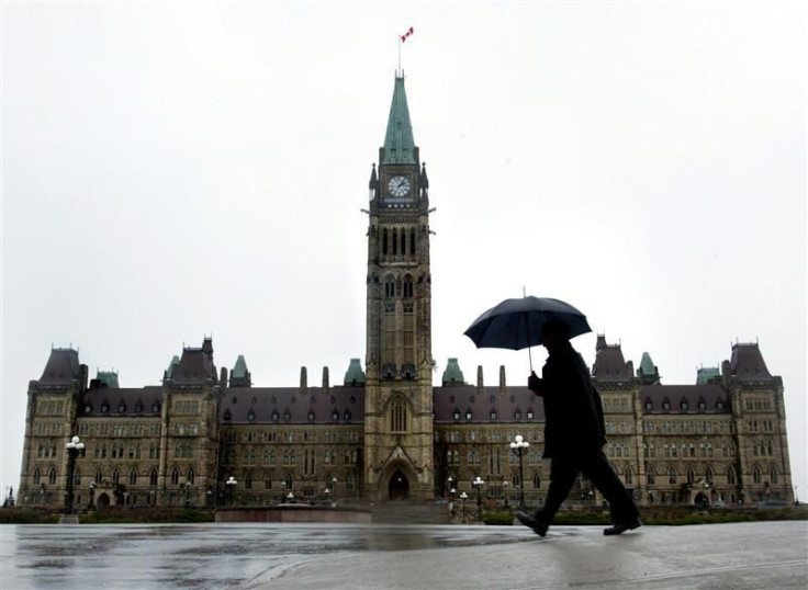 A pedestrian walks in the rain on Parliament Hill in Ottawa, November 13, 2003.
