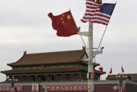 A U.S. and a Chinese flag flutter in front of Tiananmen Gate in Beijing 