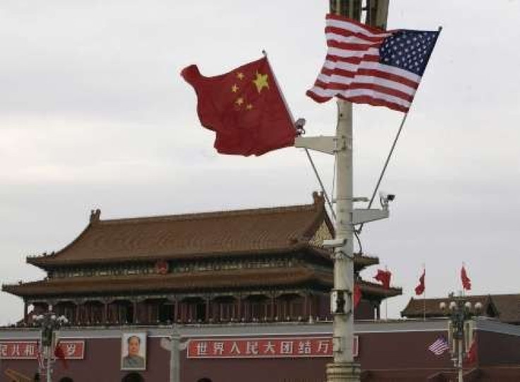 A U.S. and a Chinese flag flutter in front of Tiananmen Gate in Beijing 