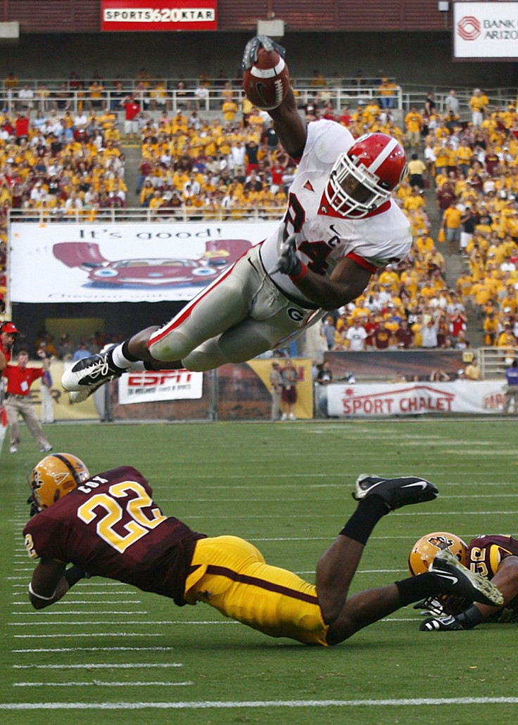 Bulldogs running back Moreno dives over Arizona State safety Cox during the first quarter of their NCAA football game in Tempe