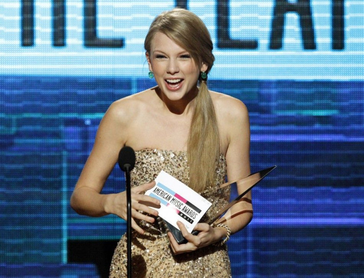 Singer Taylor Swift accepts the Artist of the Year award at the 2011 American Music Awards in Los Angeles