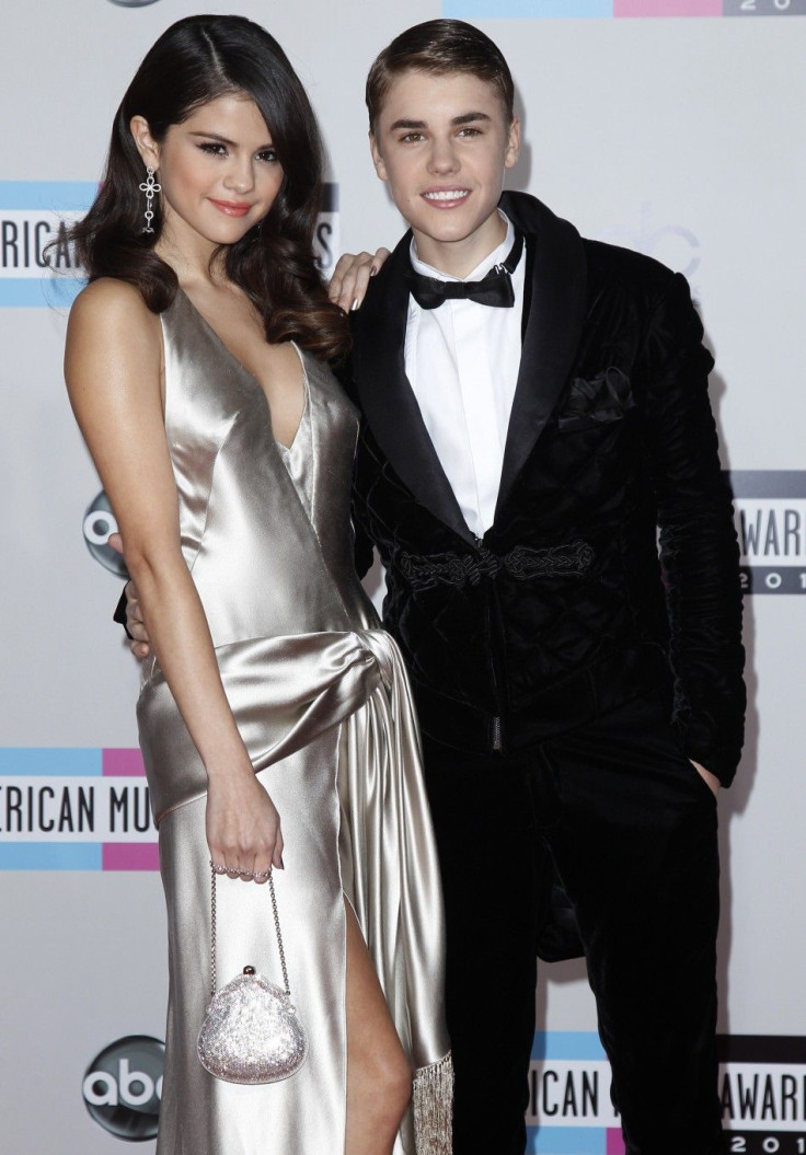 Singer Justin Bieber and his girlfriend, singer Selena Gomez arrive at the 2011 American Music Awards in Los Angeles