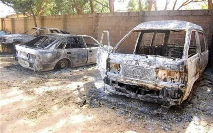 Burnt vehicles are seen at the ECWA church compound in New Jerusalem