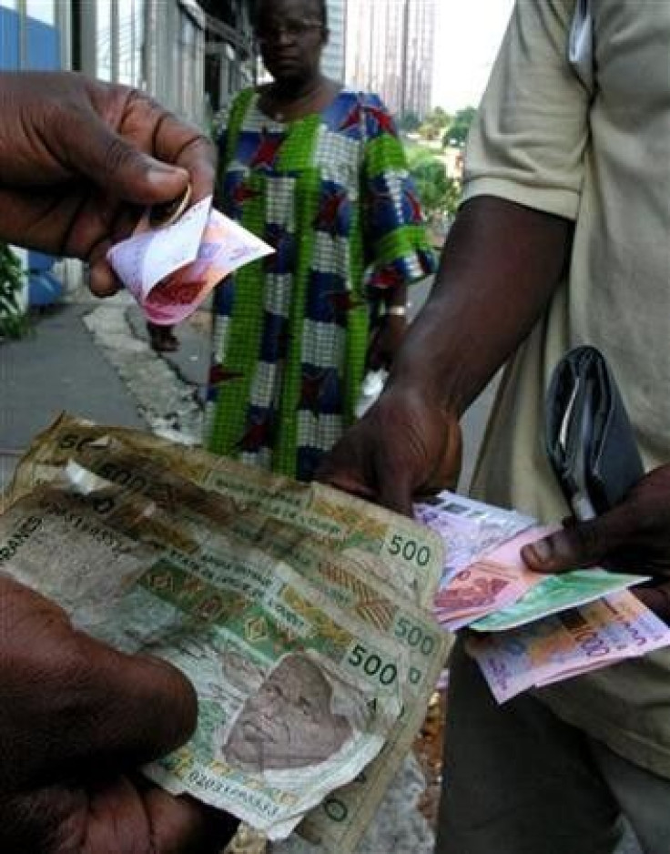 People exchange money in Abidjan