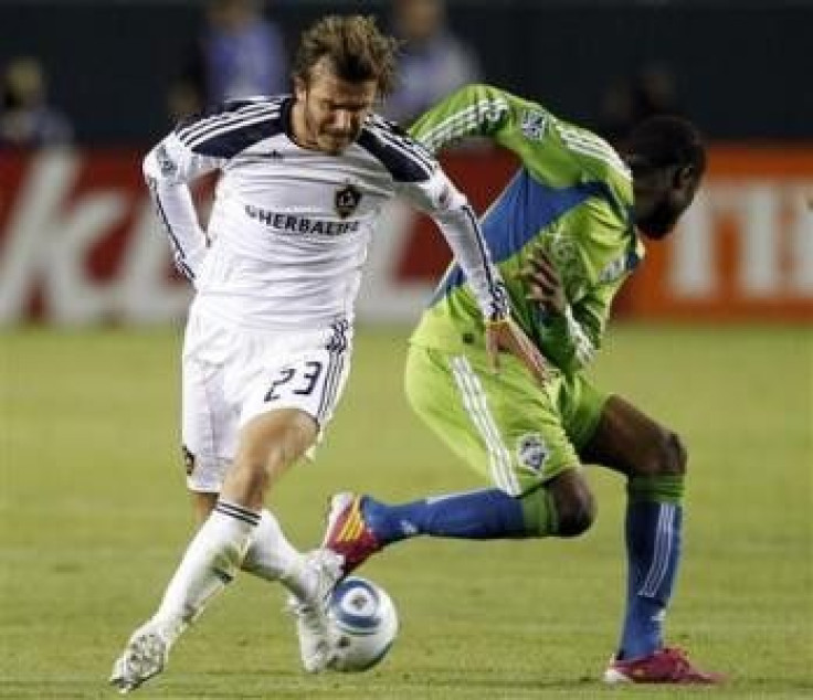 Los Angeles Galaxy's David Beckham(L) battles for the ball with Seattle Sounders' Steve Zakuani during the first half of Game 2 of their MLS Western Conference Semifinal soccer match in Carson, California, November 7, 2010.